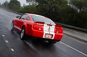 AUT 29 RK1268 01
2007 Ford Shelby Mustang GT500 Coupe Red And White 3/4 Rear View On Road In Motion