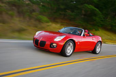 AUT 29 RK1280 01
2007 Pontiac Solstice GXP Convertible Red 3/4 Side View On Road In Motion