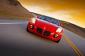 AUT 29 RK1284 01
2007 Pontiac Solstice GXP Convertible Red Slanted Head On View On Road In Motion