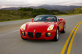 AUT 29 RK1286 01
2007 Pontiac Solstice GXP Convertible Red 3/4 Front View On Road In Motion