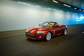 AUT 29 RK1303 01
2007 Jaguar XKR Convertible Red 3/4 Side View On Road In Motion