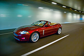 AUT 29 RK1309 01
2007 Jaguar XKR Convertible Red 3/4 Side View On Road In Motion