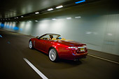 AUT 29 RK1311 01
2007 Jaguar XKR Convertible Red 3/4 Rear View On Road In Motion