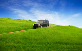 AUT 29 RK1316 01
2007 Land Rover LR3 Blue 3/4 Front View On Grass Hill In Motion