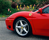 AUT 30 RK0468 02
1999 Ferrari 360 Modena Red Detail Side Of Front Tire On Pavement By Flowers