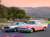 AUT 31 BK0001 01
1969 Chevrolet Camaro Z28 RS Silver And Black Stripe And 1957 Pontiac Chieftain Coral And White 3/4 Front View On Pavement By Hills
