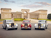 AUT 31 RK0106 01
1948 Rolls-Royce Silver Wraith Silver, 1954 Rolls-Royce Silver Dawn Silver And Maroon, 1952 Bentley R Type Silver On Pavement By Building