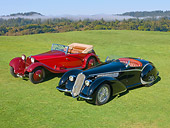 AUT 31 RK0109 01
1937 Alfa Romeo 8C 2900B Spider Black And 1934 Alfa Romeo 8C 2300 Red 3/4 Front View On Grass