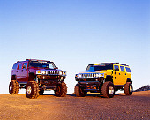 AUT 31 RK0044 05
Two 2003 Hummer H2s Yellow And Burgundy On Gravel