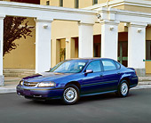 AUT 33 RK0030 04
2000 Chevrolet Impala Blue Side 3/4 View On Pavement By White Pillars