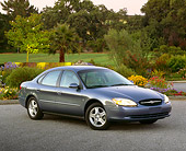 AUT 33 RK0211 02
2000 Ford Taurus SE Blue 3/4 Front View On Pavement By Flowers And Trees