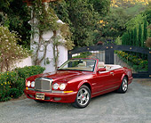 AUT 33 RK0251 02
2000 Bentley Azure Mulliner Symbolic Edition Burgundy Front 3/4 View On Gravel By Fence And Bushes