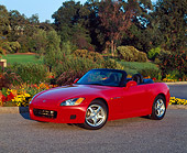 AUT 33 RK0048 01
Honda S 2000 Convertible Red 3/4 Side View On Pavement By Flowers And Trees