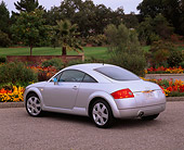 AUT 33 RK0074 04
2000 Audi Quattro TT Coupe Silver 3/4 Rear View On Pavement By Flowers And Trees