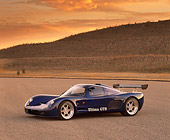 AUT 33 RK0103 07
2000 Ultima GTR Blue 3/4 Side View On Pavement Hills Background Filtered