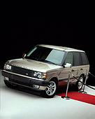 AUT 33 RK0128 06
2000 Range Rover White Gold Front 3/4 View With Red Carpet And Poles Studio