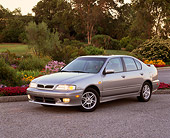 AUT 33 RK0179 14
2000 Infiniti G20 Touring Model Silver 3/4 Side View On Pavement By Flowers