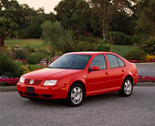 AUT 33 RK0182 03
2000 Volkswagen Jetta Red Front 3/4 View On Pavement By Flowers And Trees