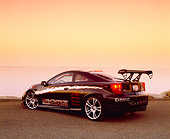 AUT 33 RK0304 06
2000 Toyota Celica GT Black With Graphics 3/4 Rear View On Pavement Water Background Filtered