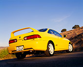 AUT 33 RK0329 01
2000 Acura Integra Type R Yellow Low 3/4 Rear View On Pavement Blue Sky