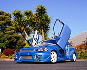 AUT 33 RK0332 01
2000 Honda Civic Custom Blue Low 3/4 Front View On Pavement Doors Up By Palm Trees
