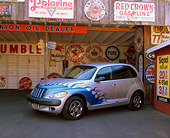 AUT 34 RK0133 03
2001 Chrysler PT Cruiser Silver Blue Flames 3/4 Side View On Pavement In Garage