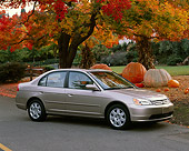 AUT 34 RK0138 01
2001 Honda Civic EX Champagne 3/4 Side View On Pavement By Pumpkins And Fall Colored Trees