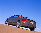 AUT 34 RK0149 01
2001 Audi TT Roadster Gray Slanted 3/4 Rear View On Pavement Hill Blue Sky