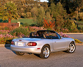 AUT 34 RK0161 04
2001 Mazda Miata Convertible Silver 3/4 Rear View On Pavement By Flowers And Trees