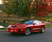 AUT 34 RK0172 05
2001 Pontiac Firebird Trans Am Sunset Orange 3/4 Front View On Pavement By Water 
And Fall Trees