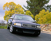 AUT 34 RK0248 02
2001 Audi S8 Blue Low 3/4 Front View On Pavement By Bridge And Trees Gray Clouds