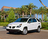 AUT 35 RK0217 02
2002 Pontiac Aztek White 3/4 Front View On Pavement By Palm Trees And Building