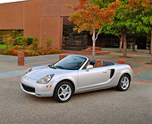 AUT 35 RK0273 01
2002 Toyota MR2 Convertible Silver 3/4 Side View On Pavement By Building