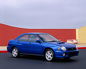 AUT 35 RK0060 01
2002 Subaru WRX Impreza Blue Front 3/4 View On Pavement By Red Fence