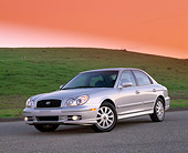 AUT 35 RK0092 01
2002 Hyundai Sonata GLS Silver 3/4 Front View On Pavement By Grass Hill Filtered