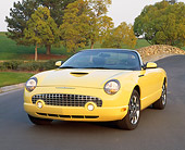 AUT 35 RK0099 01
2002 Ford Thunderbird Yellow Convertible 3/4 Front View On Pavement By Trees