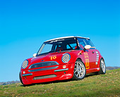 AUT 35 RK0133 05
2002 Mini Mania Mini Cooper Red Slanted 3/4 Front View On Grass Hill