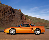 AUT 35 RK0159 04
2002 Acura NSX Imola Orange Pearl Profile On Dirt By Rock Mountain Blue Sky