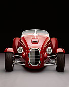 AUT 35 RK0190 02
2002 Torpedo Roadster Custom Red Head On Shot Gray Floor Studio