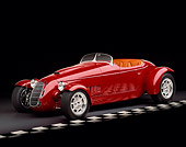 AUT 35 RK0191 04
2002 Torpedo Roadster Custom Red 3/4 Side View On Checkered Line Black Floor Studio