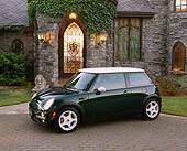 AUT 35 RK0230 02
2002 Mini Cooper Green White Top 3/4 Side View In Front Of House