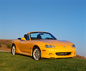 AUT 35 RK0256 04
2002 Mazda Miata Special Edition Yellow 3/4 Front View On Grass Blue Sky