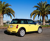 AUT 35 RK0305 02
2002 Mini Cooper S Yellow And Black 3/4 Rear View On Pavement By Palm Trees Blue Sky