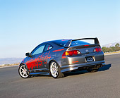 AUT 35 RK0319 03
2002 Acura RSX Nitrous Gray Red Graphics Suspension Techniques Slanted 3/4 Rear View On Pavement Blue Sky