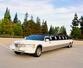 AUT 37 RK0003 09
2000 Lincoln Town Car Stretched Limousine White 3/4 Front View On Pavement By Trees