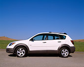 AUT 38 RK0016 08
2003 Pontiac Vibe White Low Profile View On Pavement By Grass Blue Sky