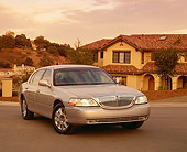 AUT 38 RK0067 02
2003 Lincoln Town Car Silver Front 3/4 View On Pavement By House