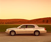 AUT 38 RK0070 03
2003 Lincoln Town Car Silver Profile On Pavement By Grass Filtered