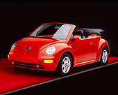 AUT 38 RK0140 08
2003 VW New Beetle Convertible Sundown Orange 3/4 Front View On Red Floor Studio