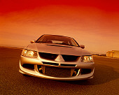 AUT 38 RK0163 02
2003 Mitsubishi Lancer Evolution VIII Silver Vishnu Tuning Head On View On Pavement